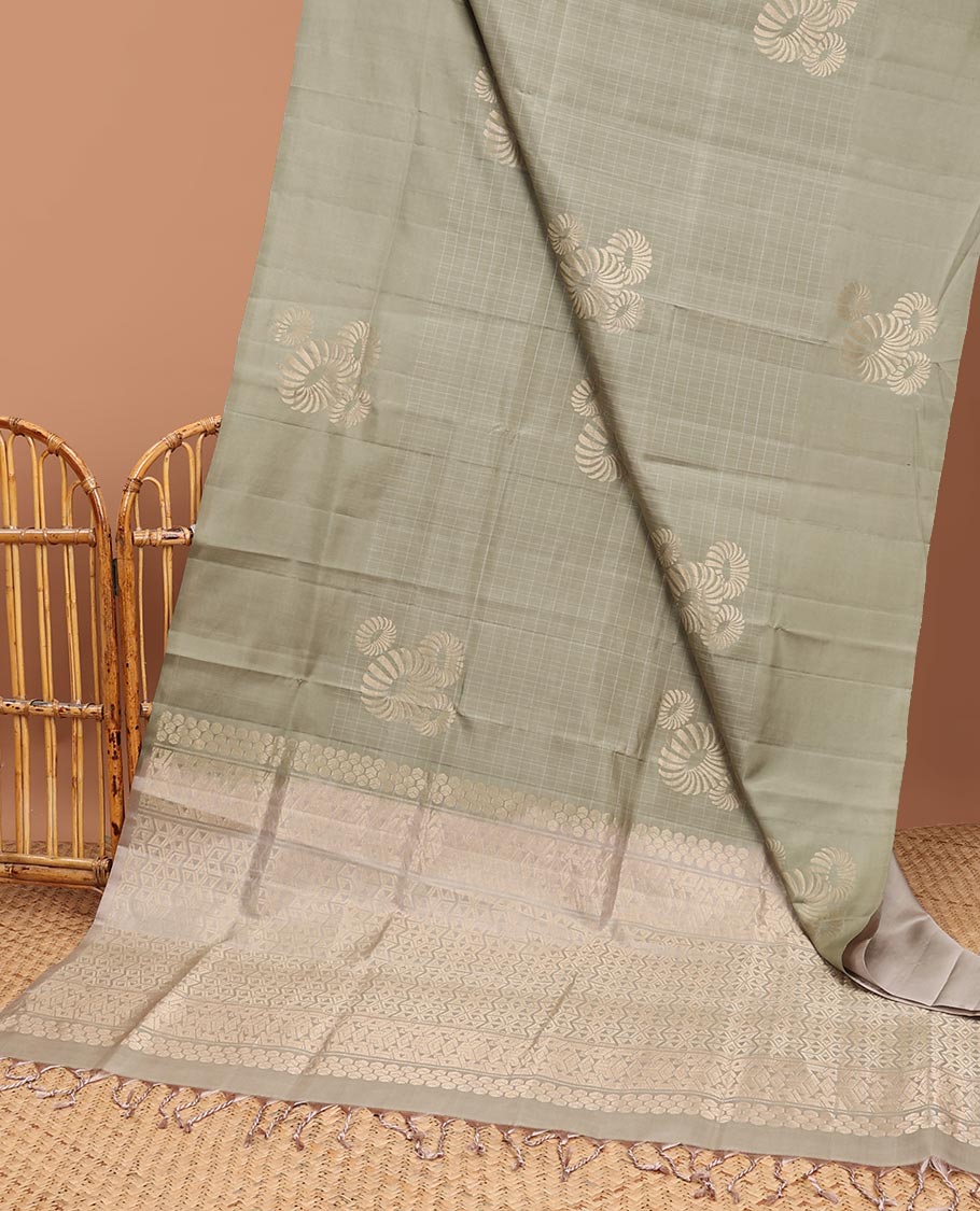 Borderless green buttas soft silk saree with intricate zari design pallu
