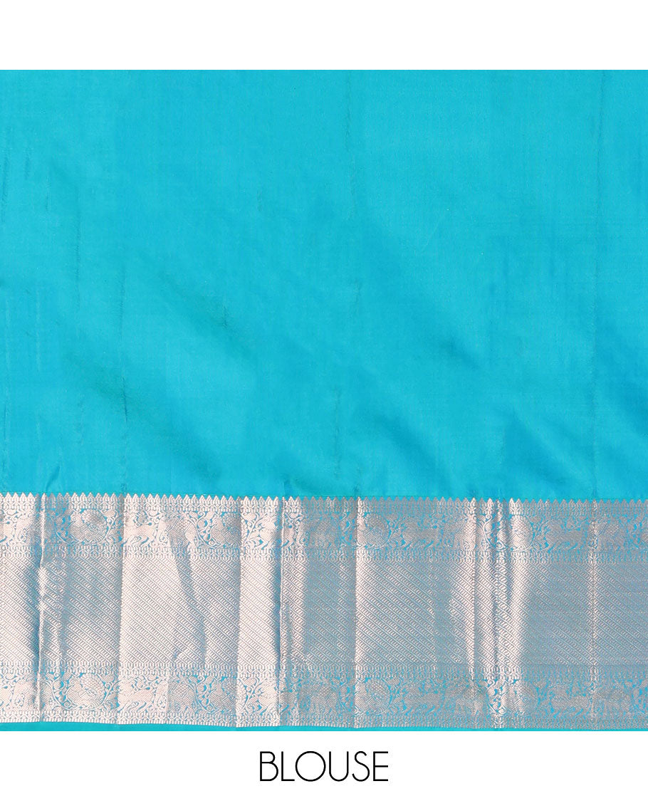 Blue Vasundhara Silk Saree, Beautifully Bedecked with Zig-Zag Stripes All Over Its Body, Highlighted by a Zari Border of Rekku, Muthu, Neli, Mayil, and Yaali Designs, Grand Jaal Pallu, and Paired with a Matching Blouse