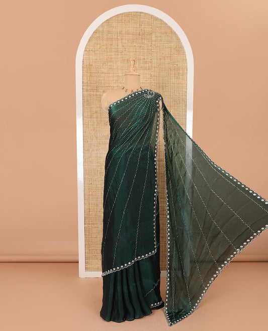 Green micro-stone work fendy chiffon saree with paisley stone work on its shoulder, a scallop stone work border, a butterfly style pallu, and a matching stone work blouse