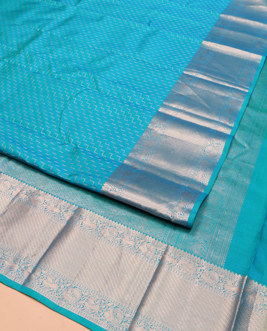 Blue Vasundhara Silk Saree, Beautifully Bedecked with Zig-Zag Stripes All Over Its Body, Highlighted by a Zari Border of Rekku, Muthu, Neli, Mayil, and Yaali Designs, Grand Jaal Pallu, and Paired with a Matching Blouse
