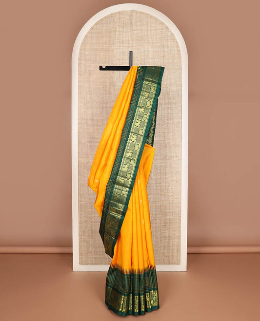 Yellow zari buttas kanchipuram silk saree, contrast one-sided thazampoo rekku checked border of annam chakram & mayil kann & intricate pallu