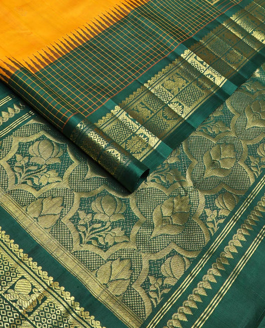 Yellow zari buttas kanchipuram silk saree, contrast one-sided thazampoo rekku checked border of annam chakram & mayil kann & intricate pallu