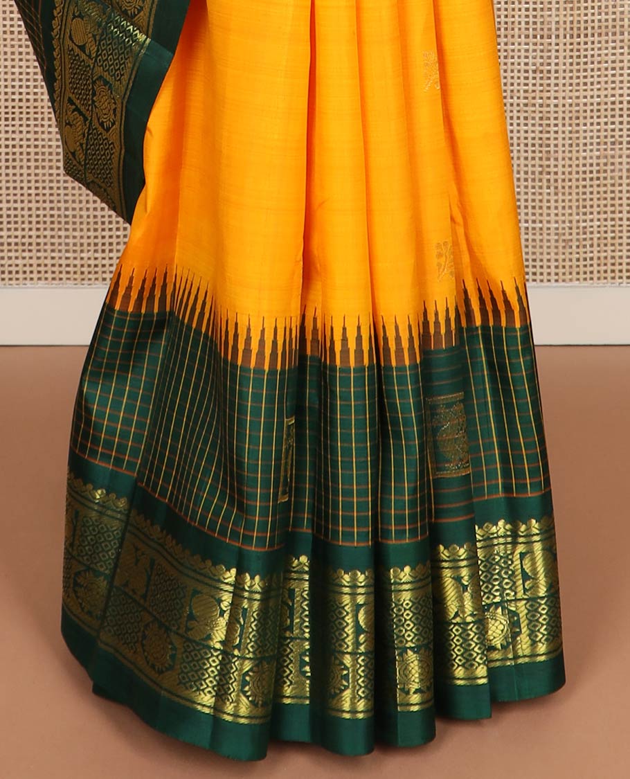 Yellow zari buttas kanchipuram silk saree, contrast one-sided thazampoo rekku checked border of annam chakram & mayil kann & intricate pallu
