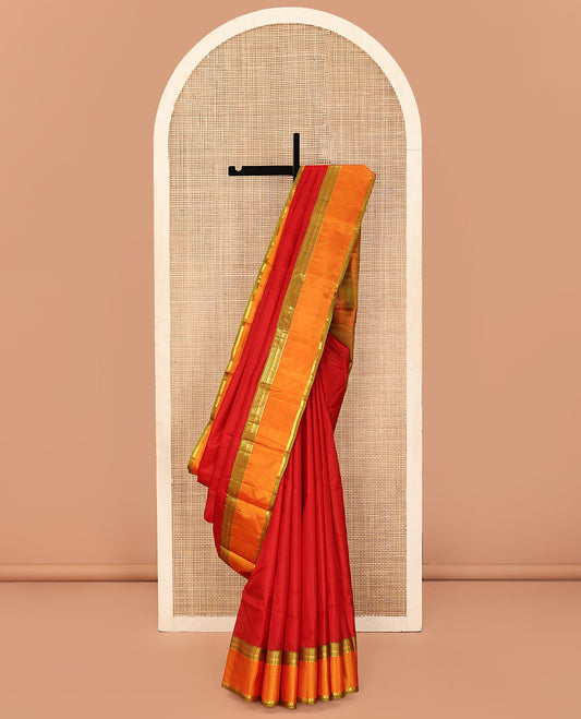 Red Plain Kanchipuram Silk Saree, Complemented by a Contrast Rettai Pettu Border of Rekku, Banaras, Neli, Rudraksham, and Vanki Star Designs, Sparsely Woven Pallu, and Paired with a Contrast Blouse
