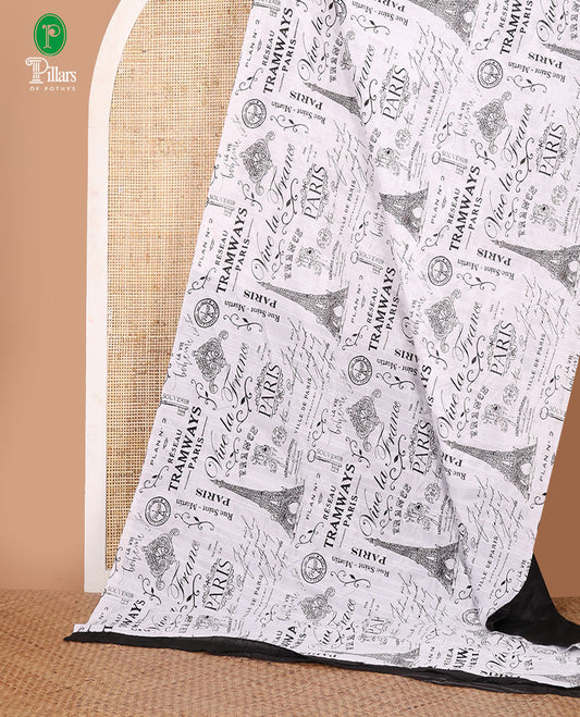 Borderless white vintage Paris-theme printed jute linen saree illustrating the Eiffel Tower & French typography, contrast black plain blouse