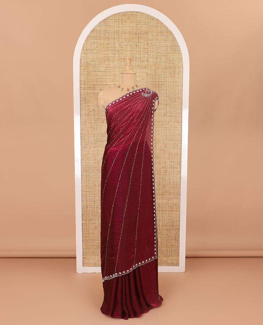Red micro-stone work fendy chiffon saree with paisley stone work on its shoulder, a scallop stone work border, a butterfly style pallu, and a matching stone work blouse