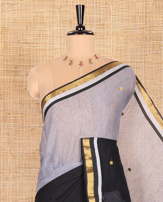 Grey and Black Khadi Mul Cotton Saree, Beautifully Bedecked with Double-Color Half-And-Half-Style Jamki Work, Complemented by Contrast Zari Border, and Paired with a Matching Blouse