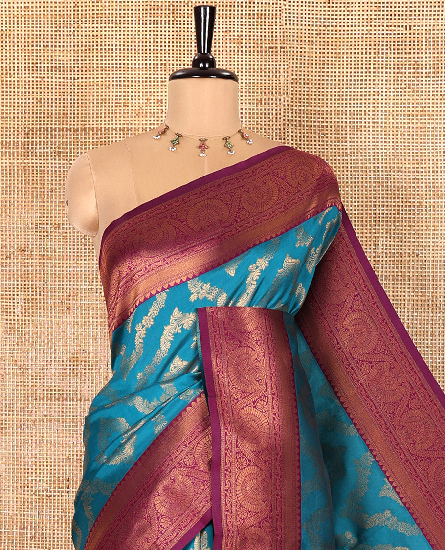 Blue Kanchi Silk Saree Mesmerized with Floral Jacquard Design All Over Its Body, Complemented by a Contrast Traditional Zari Border of Floral Creeper Designs, an Opulently Embellished Pallu, and Paired with a Contrast Jacquard Blouse