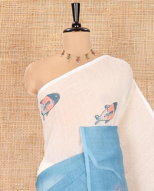 Borderless Cream and Blue Linen Cotton Saree, Accentuated with Half-and-Half Style Fish Motifs Printed All Over Its Body, Pallu Mirrors the Same Print, and Is Paired with a Contrast Blouse