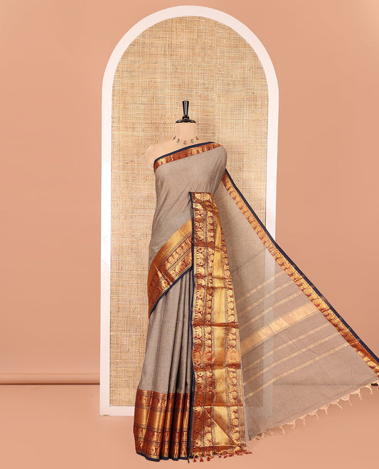 Beige Plain Chettinad Cotton Saree, Complemented by Contrast Traditional Zari Border of Peacock and Elephant Designs, Zari Striped Pallu, and Paired with a Matching Blouse