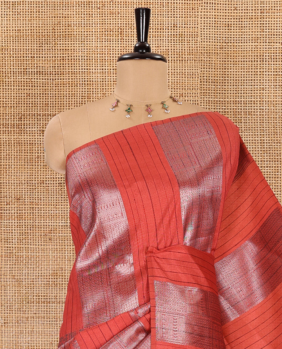 Borderless, rust orange striped, and zari traditional kanchi motifs fancy tussar saree, intricately zari-woven pallu, and a matching zari buttas woven blouse
