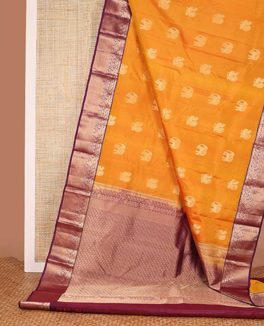 Yellow mayil and yaanai buttas silk saree, contrast border of thilakam mokku, neli, manga and yaali designs and jaal pallu