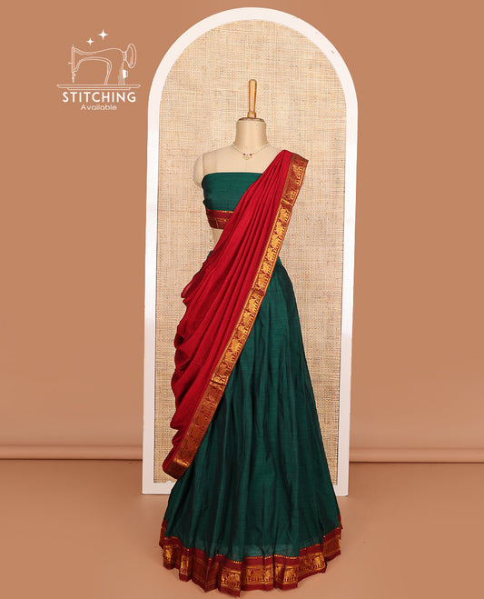 Green cotton half-saree, plain with contrast elephant motif bordered skirt, matching blouse, and contrast elephant motif bordered dhavani