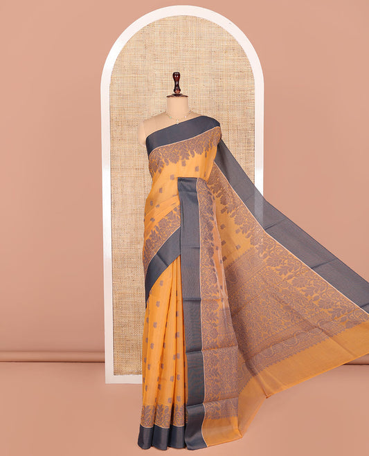Orange Semi-Silk Cotton Saree, Designed with Buttas All Over Its Body, Complemented by a Contrast Border, Pallu of Floral-Leaf Designs, and Paired with a Matching Blouse