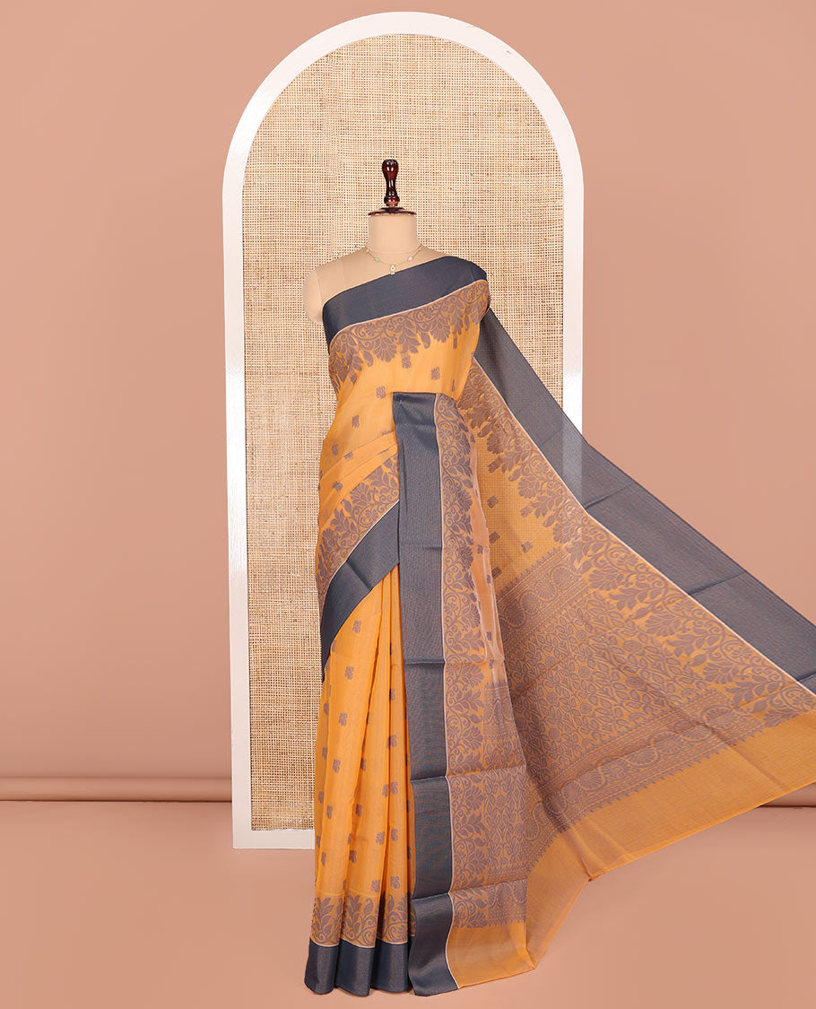 Orange Semi-Silk Cotton Saree, Designed with Buttas All Over Its Body, Complemented by a Contrast Border, Pallu of Floral-Leaf Designs, and Paired with a Matching Blouse