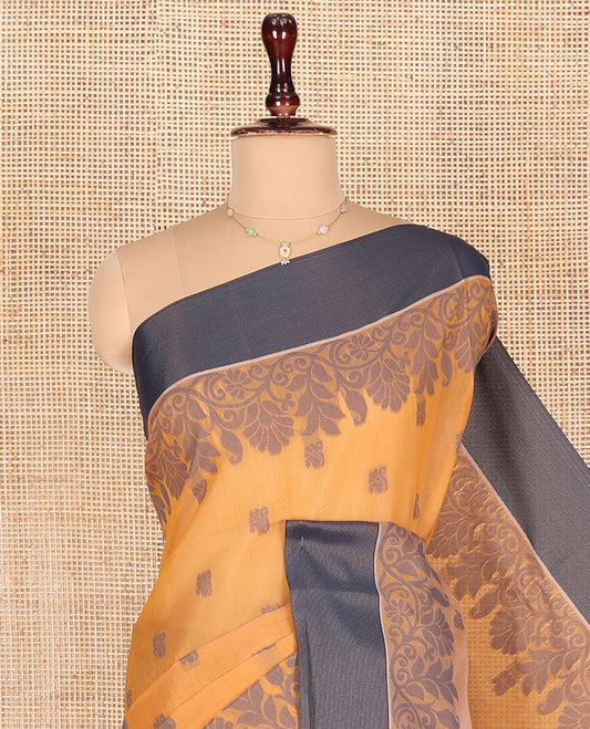 Orange Semi-Silk Cotton Saree, Designed with Buttas All Over Its Body, Complemented by a Contrast Border, Pallu of Floral-Leaf Designs, and Paired with a Matching Blouse