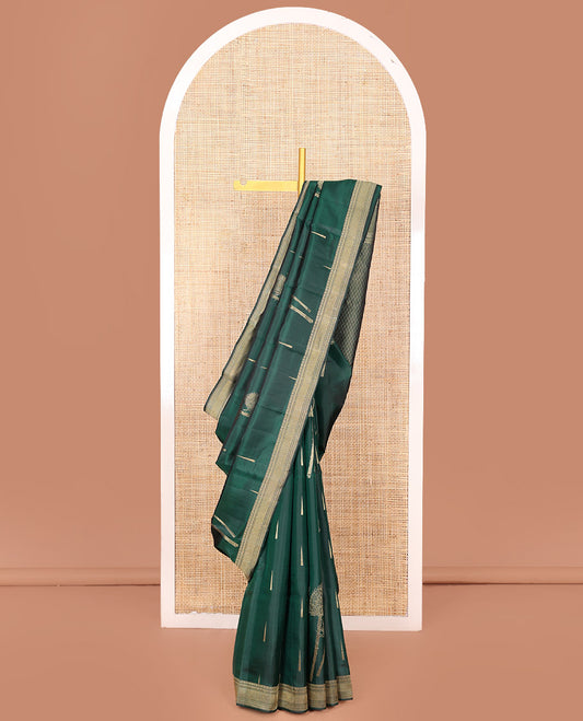 Green Vasundhara Silk Saree Creatively Designed with Thazampoo Rekku Buttas and Vel Buttas, Highlighted with a Zari Border of Manga, Muthu, Kathir, Neli, and Vanki Designs, Subtly Sparkled Pallu of Jaal Design, and Paired with a Matching Blouse