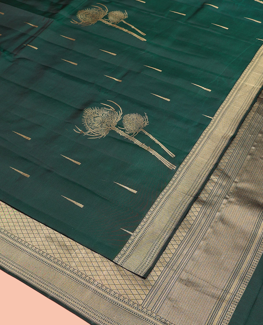 Green Vasundhara Silk Saree Creatively Designed with Thazampoo Rekku Buttas and Vel Buttas, Highlighted with a Zari Border of Manga, Muthu, Kathir, Neli, and Vanki Designs, Subtly Sparkled Pallu of Jaal Design, and Paired with a Matching Blouse