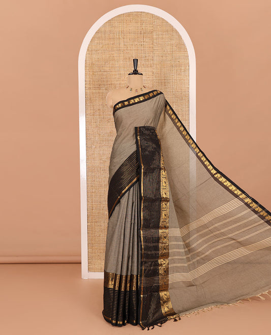 Grey plain chettinad cotton saree, contrast traditional zari border of peacock motifs, striped pallu, and a matching blouse