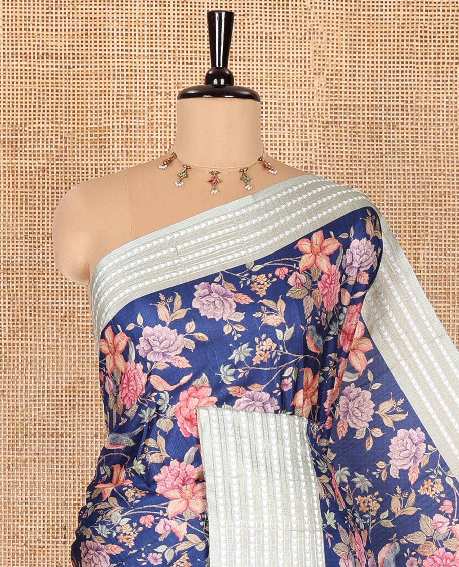 Royal blue colorful floral motifs printed fancy tussar saree, contrast triangle motifs border, striped pallu, and a contrast striped blouse