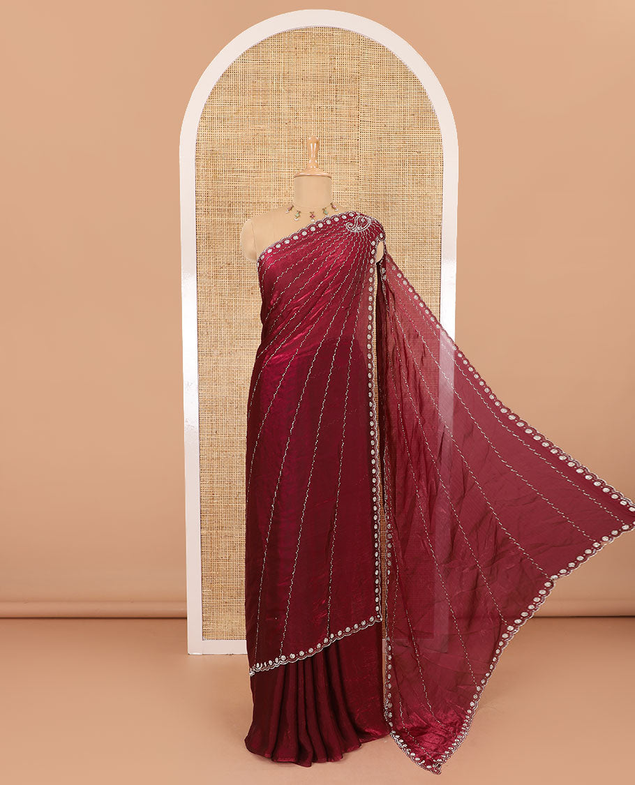 Red micro-stone work fendy chiffon saree with paisley stone work on its shoulder, a scallop stone work border, a butterfly style pallu, and a matching stone work blouse