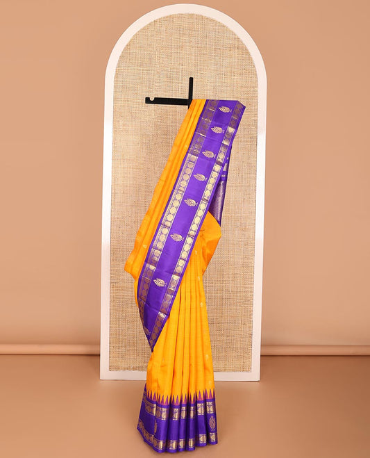 Orange buttas kancheepuram silk saree with contrast rettai prttu border of thilakam mokku, banaras, paun design & striped pallu
