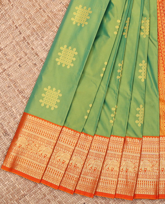 Green Budget Silk Saree Features Kolam Buttas, Complemented by a Contrast Traditional Zari Border, Grand Pallu, and a Contrast Blouse