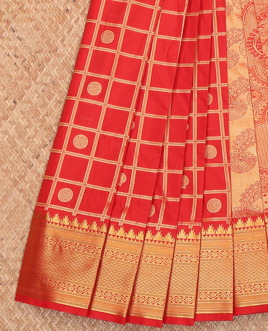 Red Budget Silk Saree, Detailed with Peacock-Chakram Butta Enclosed Checks All Over Its Body, Highlighted by a Temple Zari Border of Traditional Designs, Pallu Depicts Mughal-Style Intricate Designs, and Paired with a Matching Blouse