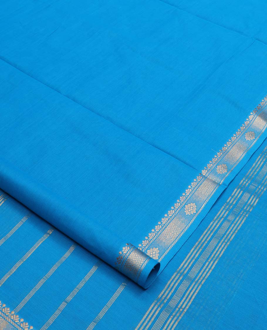 Sky blue plain nine-yard cotton saree, traditional zari border, and striped pallu