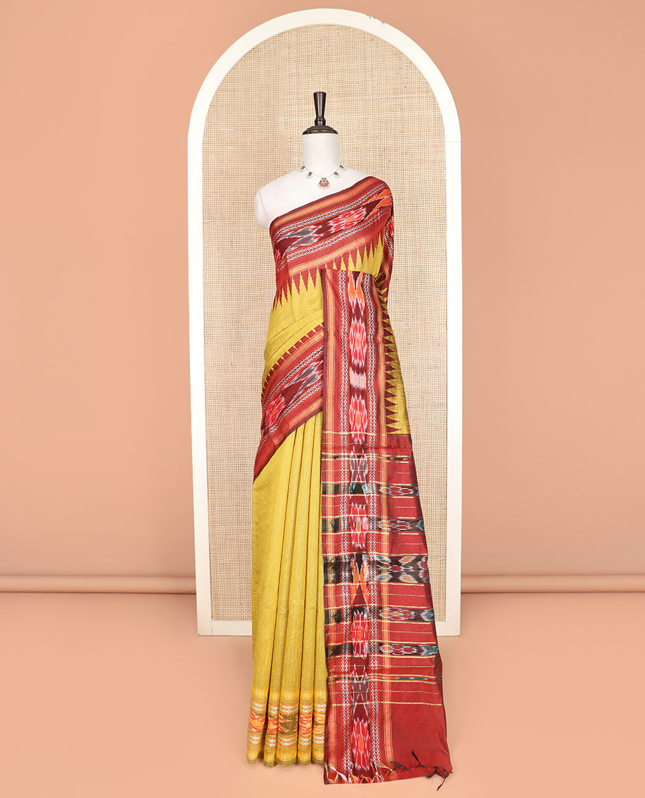 Yellow Plain Dupion Silk Saree, Captivated by a Contrast Temple Border of Geometric Patterns and Ikkat Weave, Pallu Depicting Floral Ikkat Designs, and Paired with a Contrast Blouse