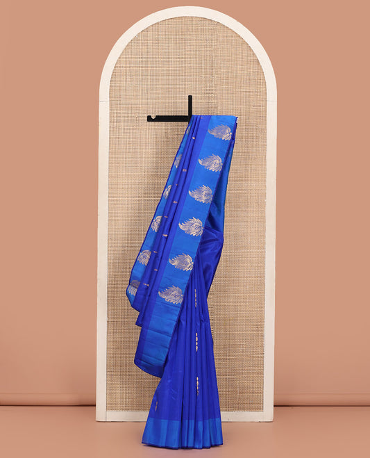 Royal Blue Kanchipuram Silk Saree Adorned with Zari Buttas, Complemented by a Contrast Border of Leaf Zari  Designs, Sparsely Zari Woven Pallu, and Paired with a Contrast Blouse