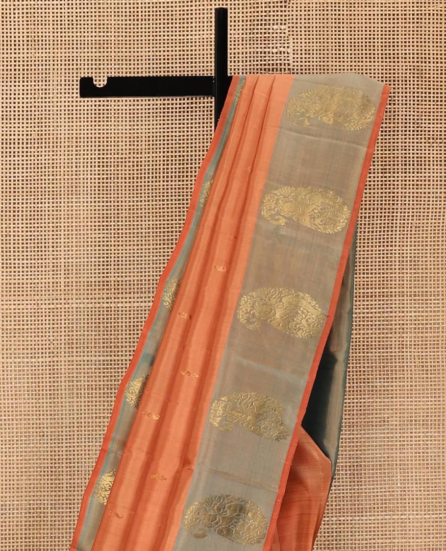 Orange Kanchipuram Silk Saree, Adorned with Zari Buttas All Over Its Body, Complemented by a Contrast  Border of Manga Designs, Pallu of Manga Designs, and Paired with a Contrast Blouse