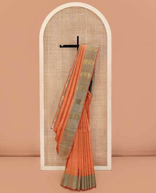 Orange Kanchipuram Silk Saree, Adorned with Zari Buttas All Over Its Body, Complemented by a Contrast  Border of Manga Designs, Pallu of Manga Designs, and Paired with a Contrast Blouse