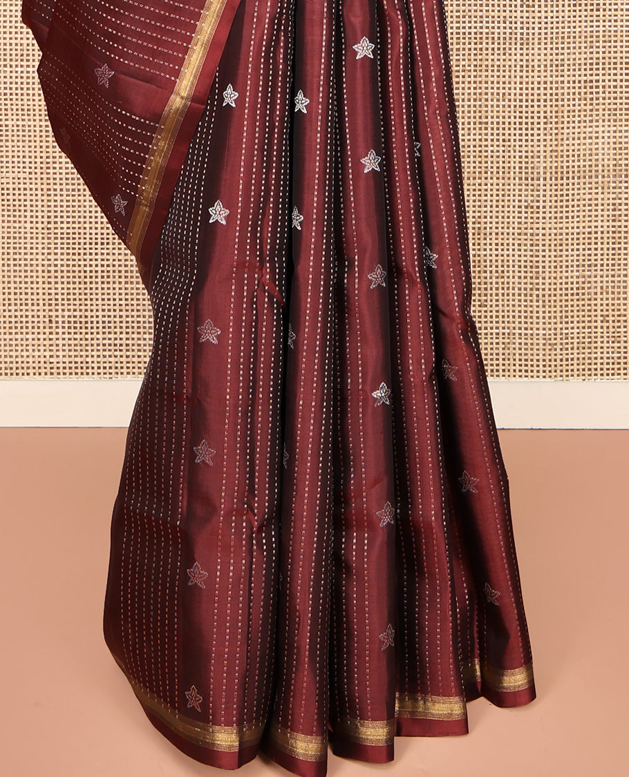 Maroon Mayuri Lite Silk Mix Saree, Adorned with Buttas and Muthu Stripes All Over Its Body, Highlighted by a Zari Border, Pallu of Intricate Designs, and Paired with a Matching Blouse
