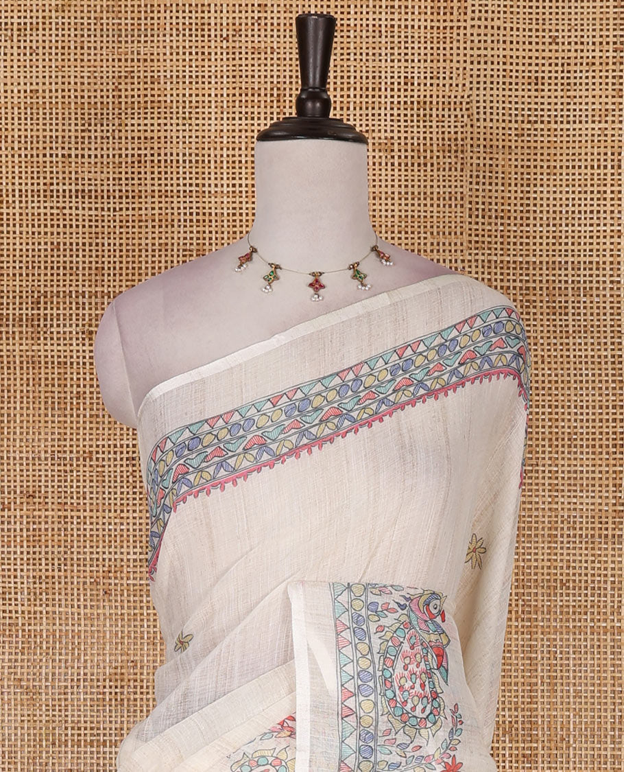 Cream madhubani-style floral buttas printed linen saree, madhubani peacock printed border, madhubani printed pallu, and madhubani village printed blouse