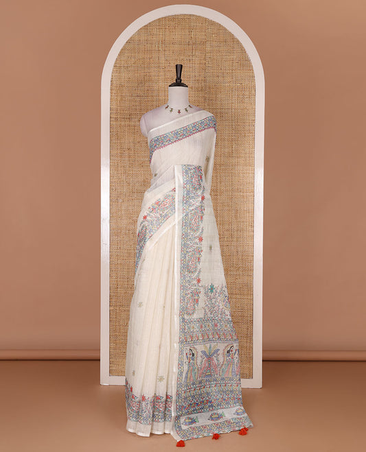Cream madhubani-style floral buttas printed linen saree, madhubani peacock printed border, madhubani printed pallu, and madhubani village printed blouse