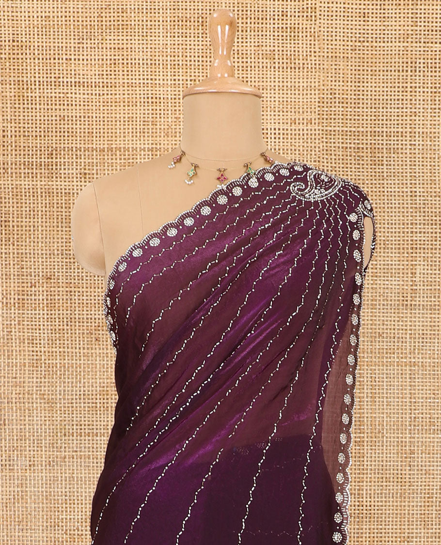 Wine micro-stone work fendy chiffon saree with paisley stone work on its shoulder, a scallop stone work border, a butterfly style pallu, and a matching stone work blouse