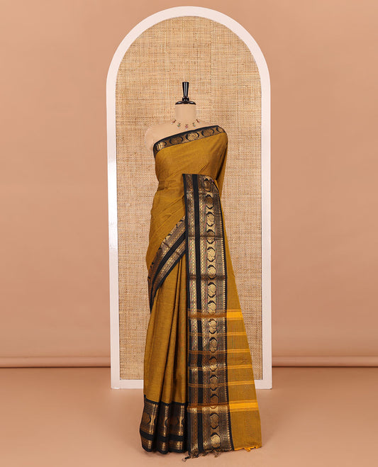 Gold plain design chettinad cotton saree, contrast traditional zari border of peacock motifs, striped pallu, and a matching blouse