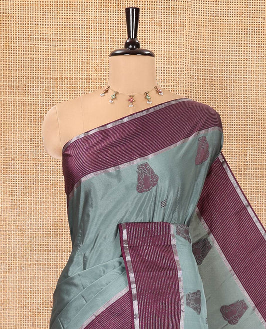 Green Soft Silk Saree, Mesmerized with Elephant Motifs All Over Its Body, Complemented by a Contrast Zari Striped Border, Pallu Depicts Big Elephant Motifs, and Paired with a Matching Blouse