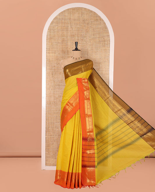 Yellow Plain Chettinad Cotton Saree, Complemented by Contrast Traditional Zari Design Ganga-Jamuna Border of Peacock-Chakram Designs, Subtly Striped Pallu, and Paired with a Matching Blouse