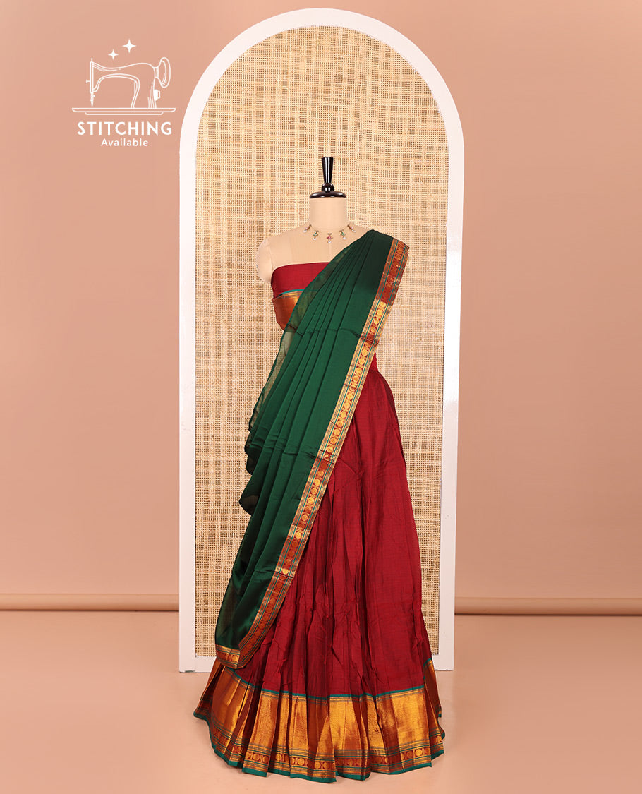 Maroon and Green Mercerised Cotton Half-Saree Featuring Plain Skirt, Adorned with a Contrast Peacock Eye-Rudraksham Motifs Woven Zari Border, Paired with a Matching Blouse, and Contrast Syska Georgette Dhavani with Zari Border