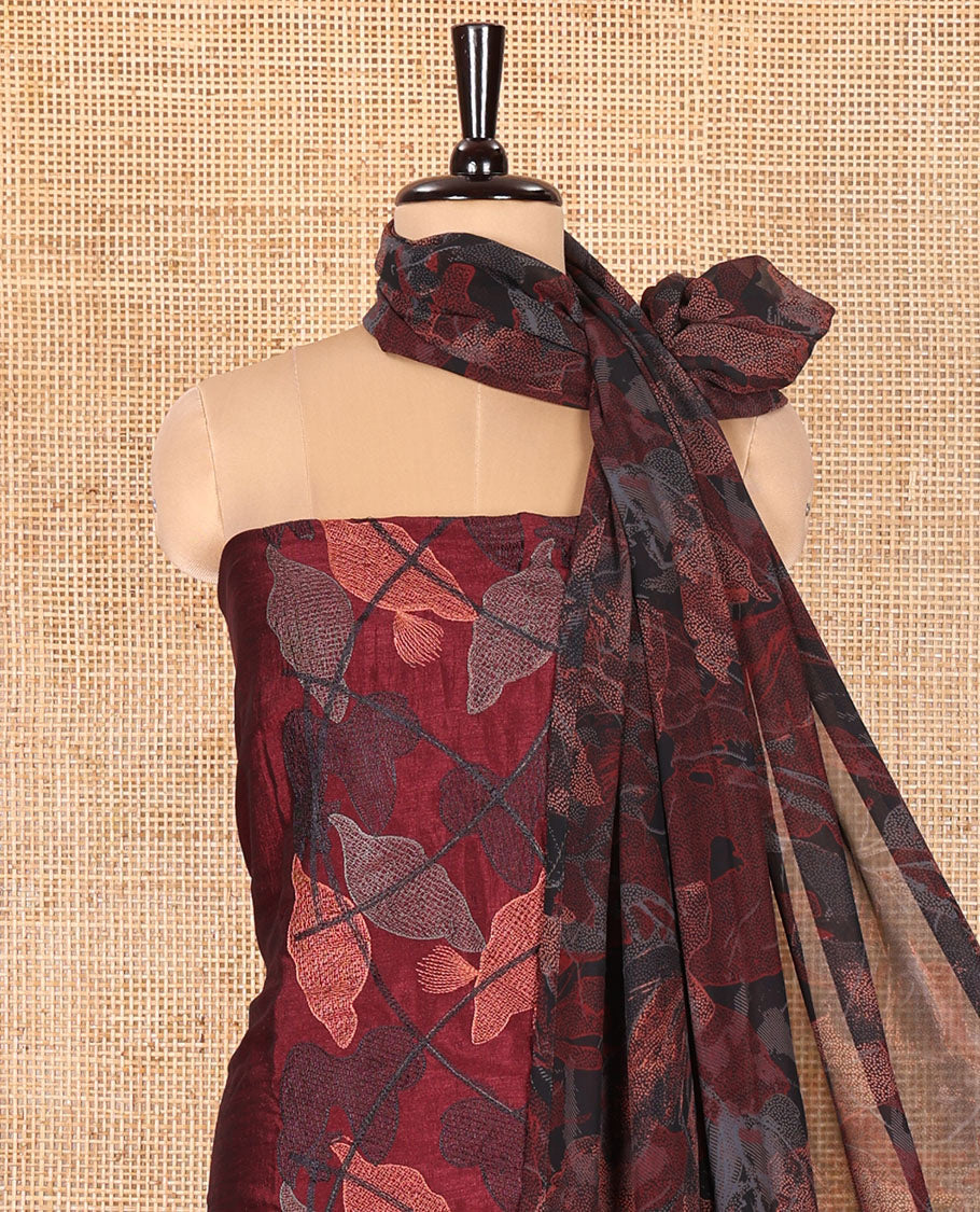 Maroon Vichitra Silk Designer Material Chudidar Set, Elegantly Detailed with Floral Cross-Stiched Embroidered Top, A Subtly Plain Santoon Bottom, and Paired with a Georgette Abstract Printed Dupatta
