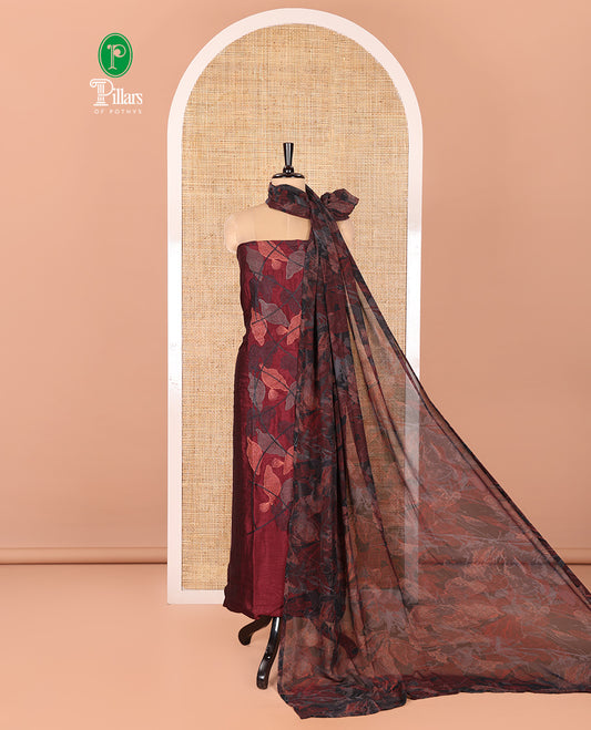 Maroon Vichitra Silk Designer Material Chudidar Set, Elegantly Detailed with Floral Cross-Stiched Embroidered Top, A Subtly Plain Santoon Bottom, and Paired with a Georgette Abstract Printed Dupatta