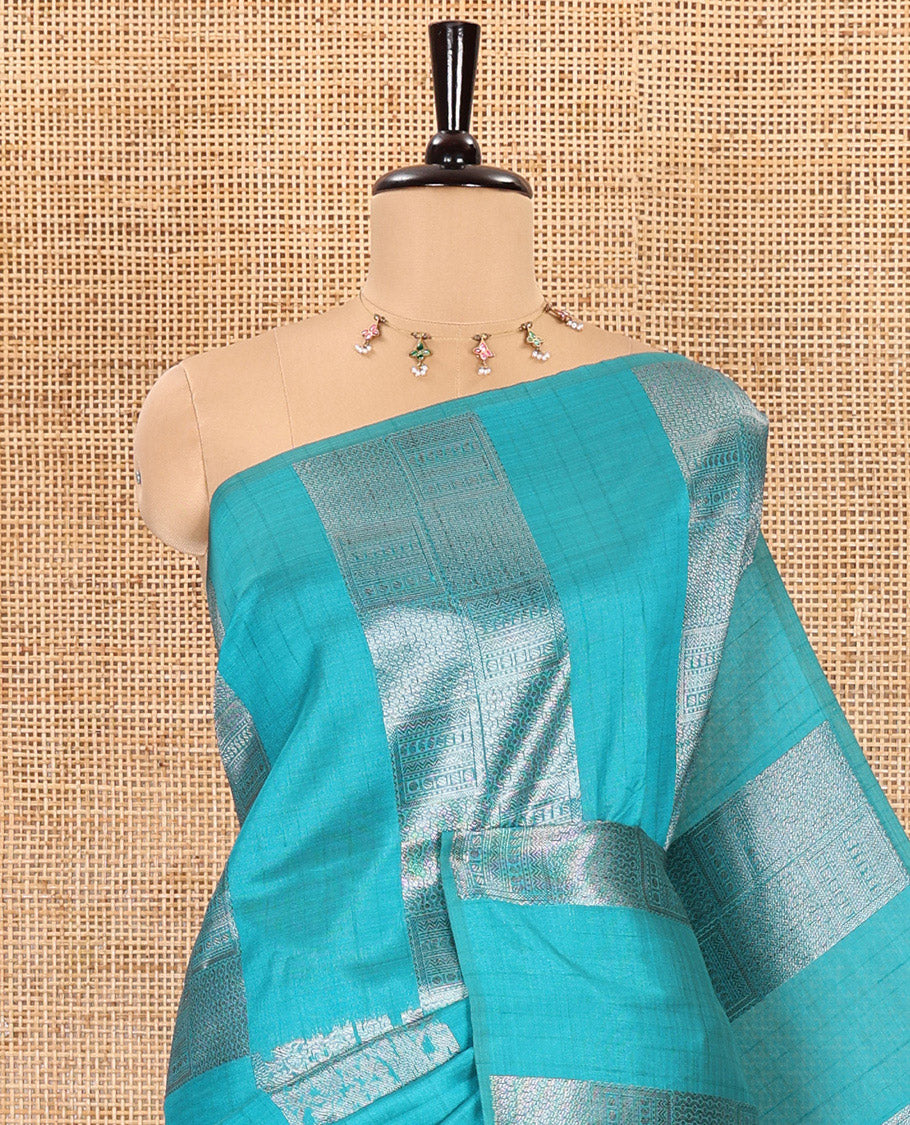 Borderless, blue striped, and zari traditional kanchi motifs fancy tussar saree, intricately zari-woven pallu, and a matching zari buttas woven blouse