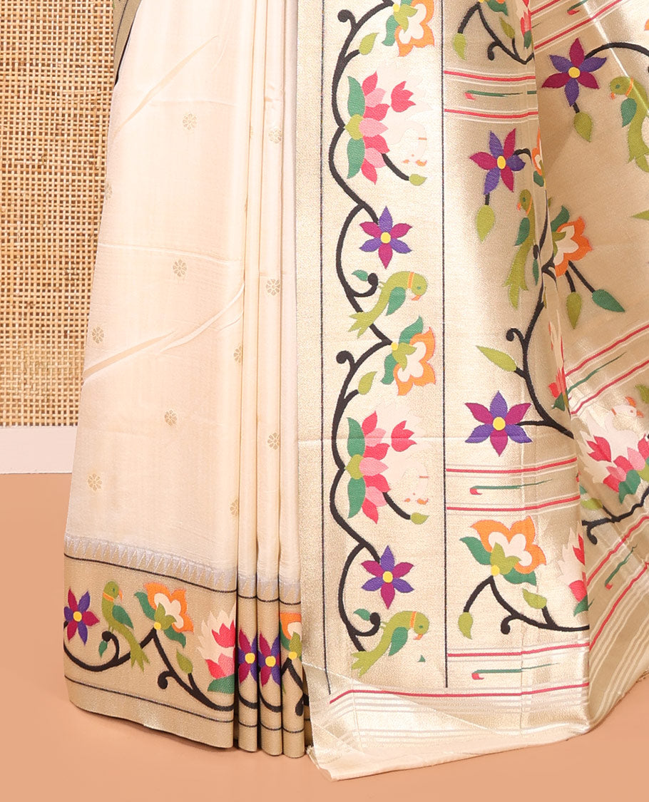 Half-White Paithani Art Silk Saree, Enthralled with Flower Buttas All Over Its Body, Highlighted by Zari Border Pictures Colorful Floral, and Parrot Designs, Pallu of Muniya, Floral and Parrot Designs, and Paired with a Matching Blouse