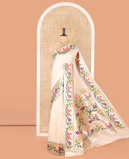 Half-White Paithani Art Silk Saree, Enthralled with Flower Buttas All Over Its Body, Highlighted by Zari Border Pictures Colorful Floral, and Parrot Designs, Pallu of Muniya, Floral and Parrot Designs, and Paired with a Matching Blouse