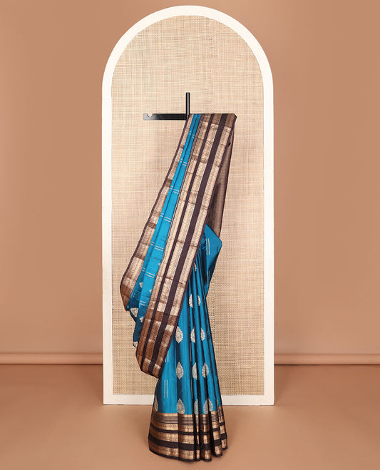 Blue vasundhara elite silk saree with zari buttas, contrast border of thilakam,muthu,neli,poun,mayil kann & mayil & jaal pallu