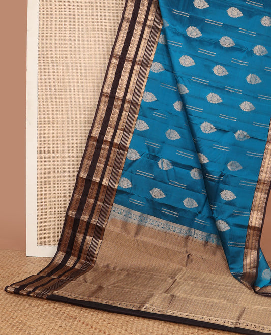 Blue vasundhara elite silk saree with zari buttas, contrast border of thilakam,muthu,neli,poun,mayil kann & mayil & jaal pallu