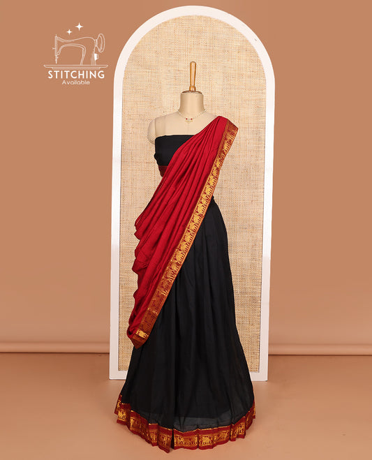 Black cotton half-saree, plain with contrast elephant motif bordered skirt, matching blouse, and contrast elephant motif bordered dhavani