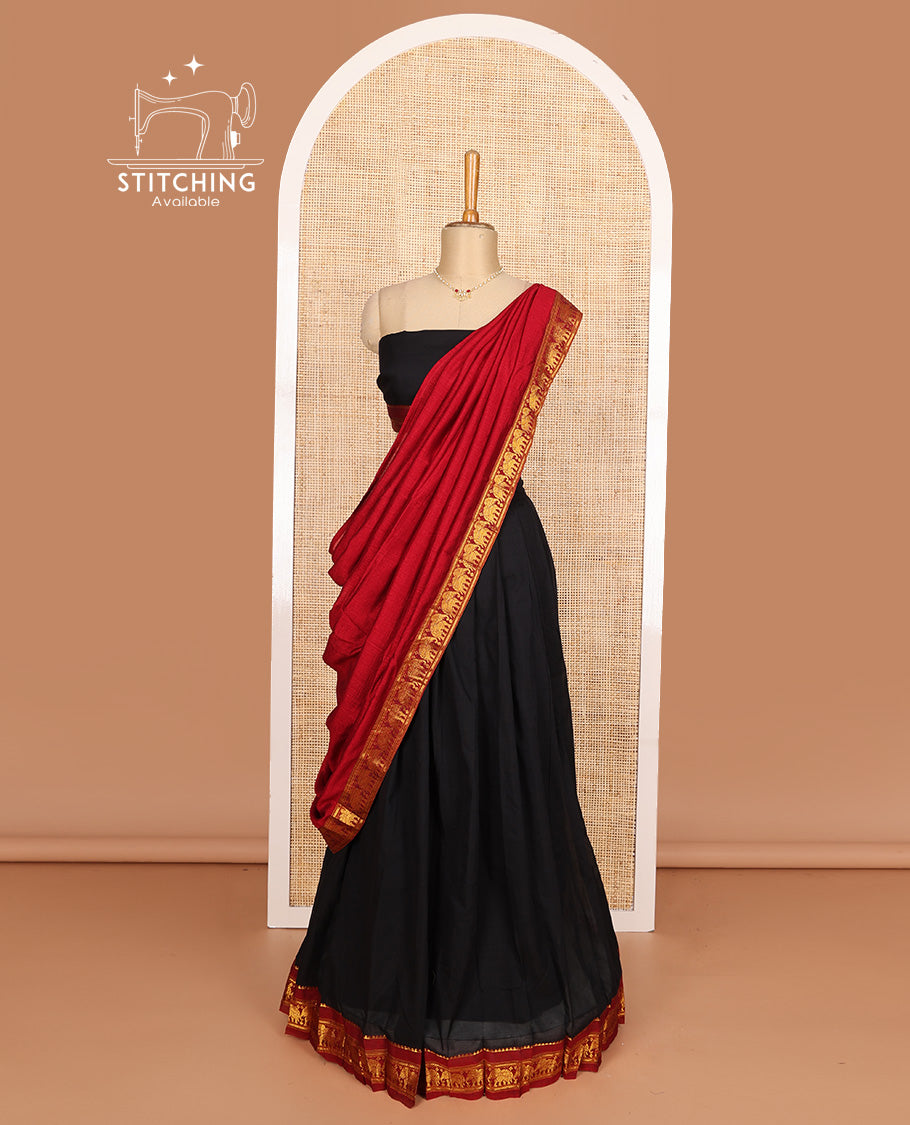 Black cotton half-saree, plain with contrast elephant motif bordered skirt, matching blouse, and contrast elephant motif bordered dhavani